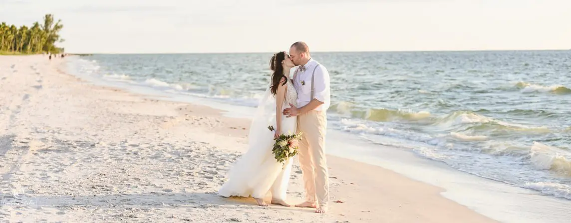 Naples beach wedding couple kissing