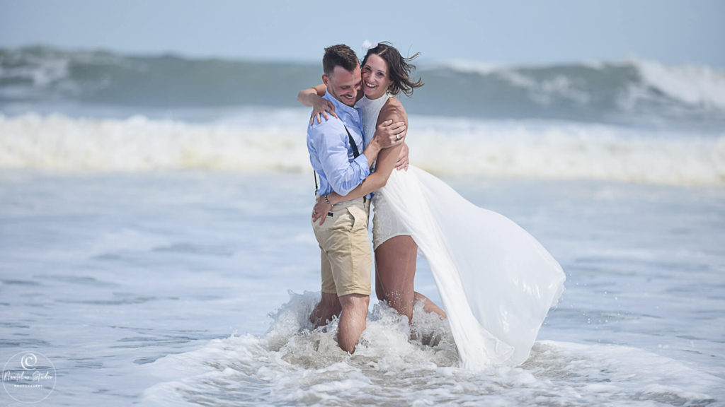 Cocoa Beach Strandhochzeit zeigt Brautpaar in den Wellen